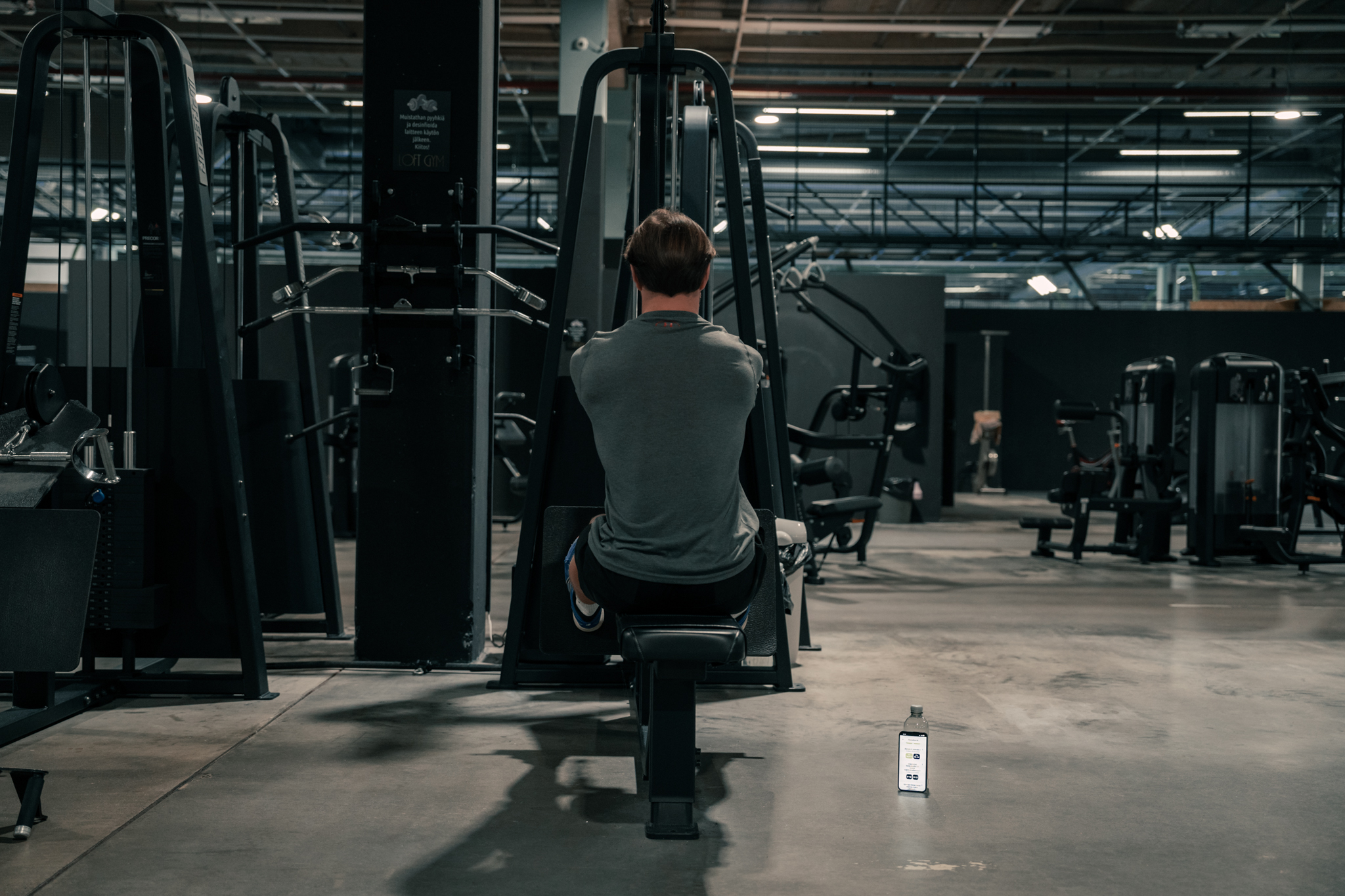 person is doing a seated cable-row in a gym