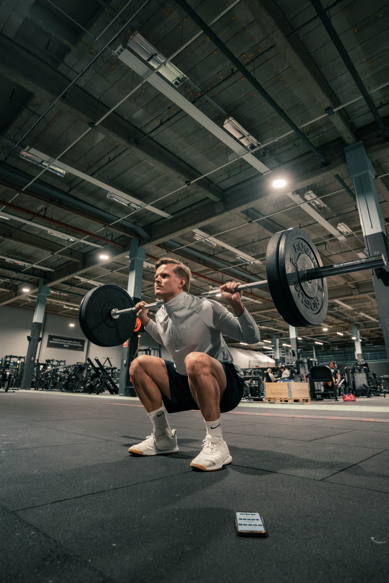 A lifter performing a barbell squat at the gym