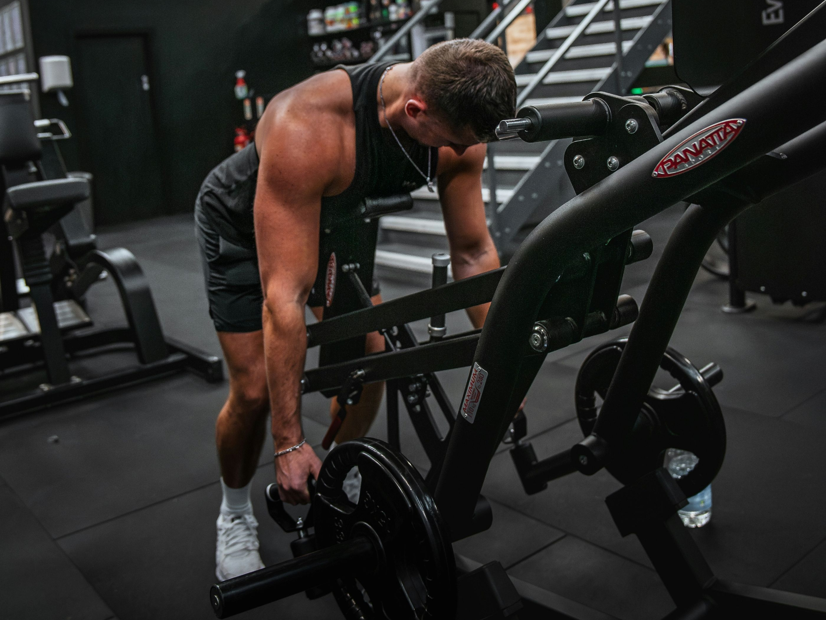 A man performing a chest-supported row at the gym as a back exercise.
