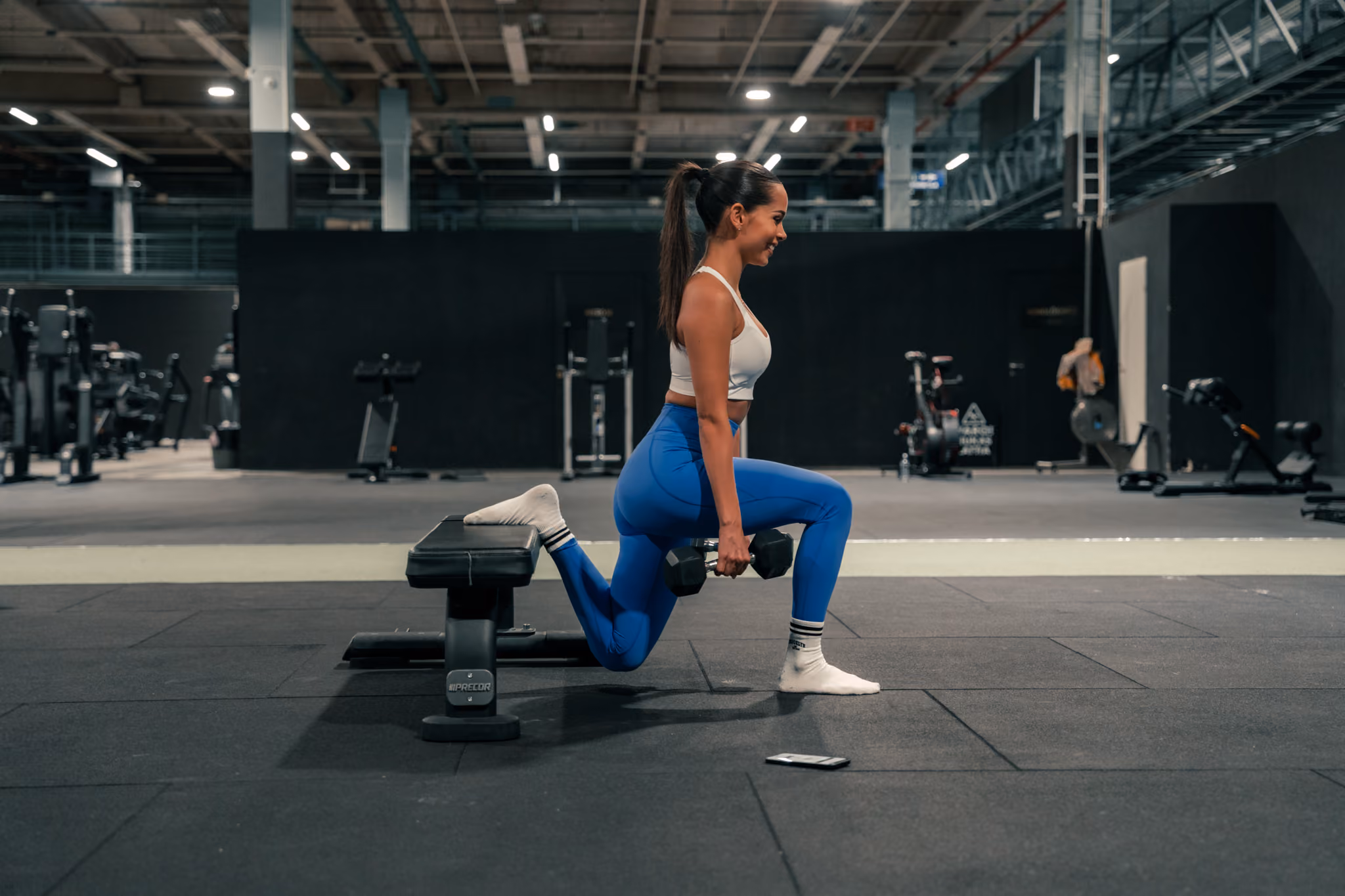A single-leg squat with a long stride loads the glute in a stretched position