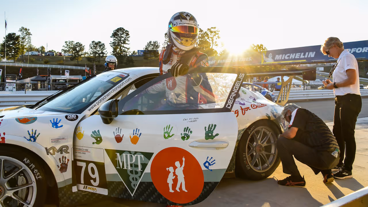 Kellymoss race driver stepping out of a Porsche race car, representing expanded visibility for diverse drivers in motorsports.