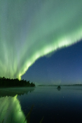 Northern Lights is reflecting from lake