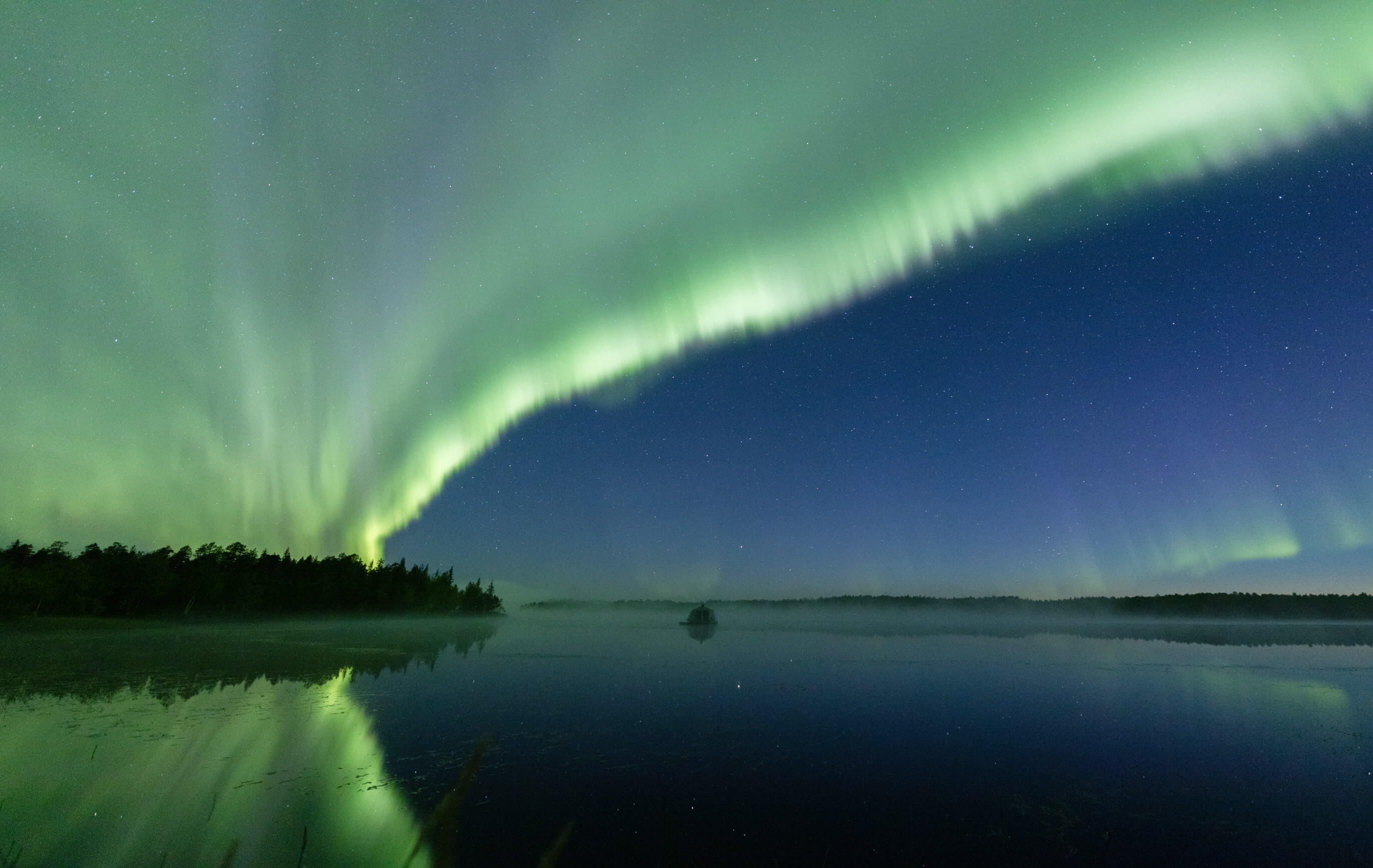 Aurora Borealis is shining over the lake 