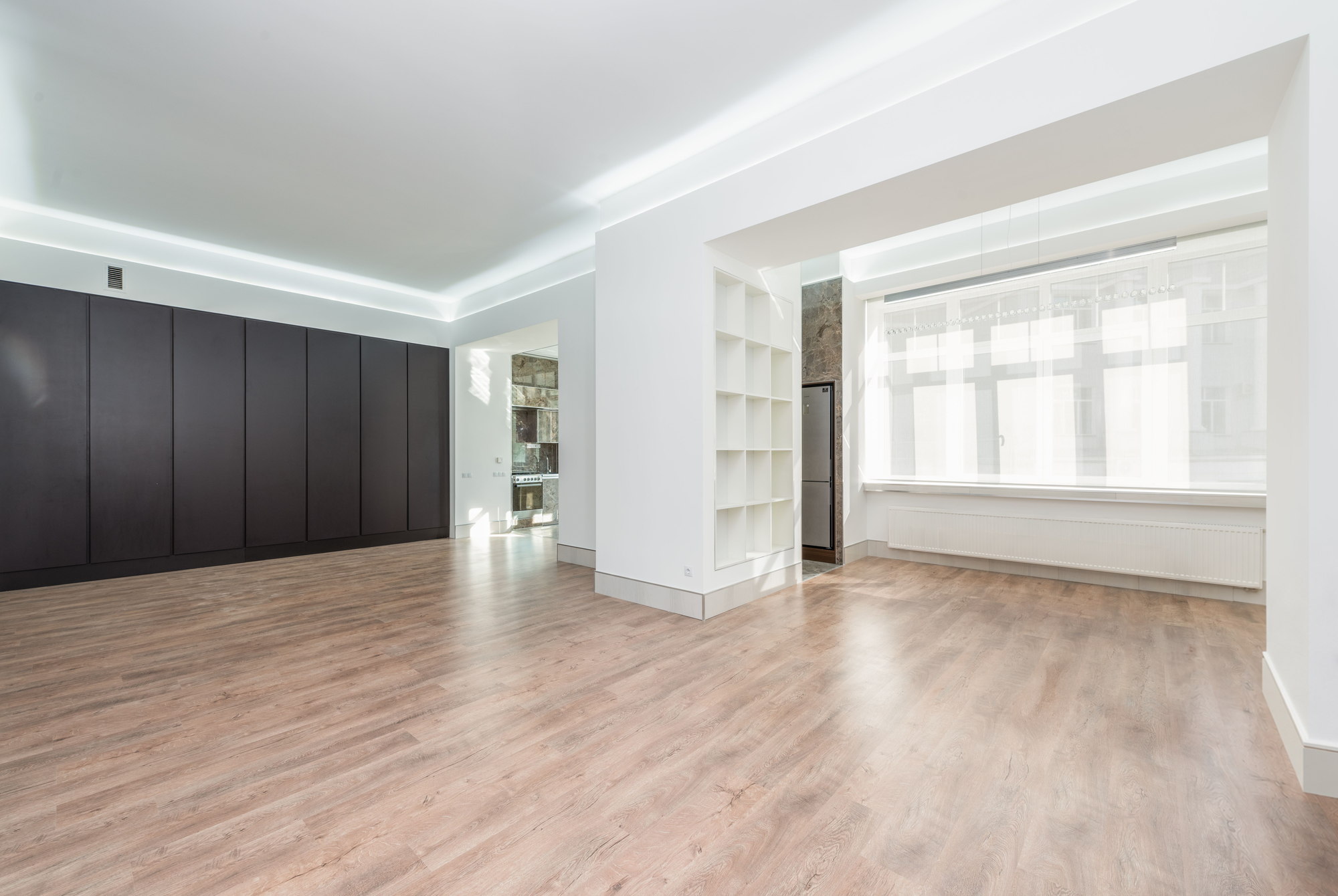 The same third angle empty, showing the dark panelled wall, the alcove shelving and bare floorboards