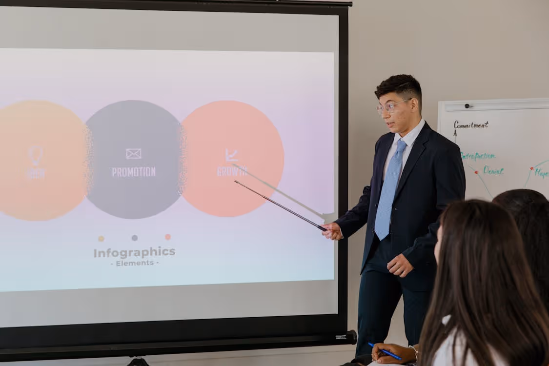 Free Professional business presentation featuring infographic elements on a screen. Stock Photo