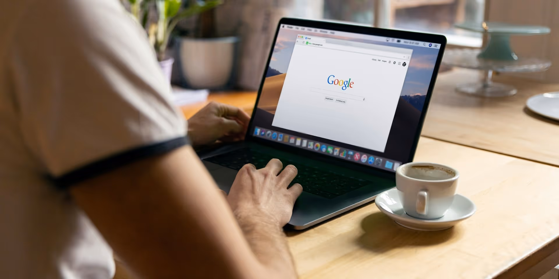 A man sitting at his laptop with Google open on his web browser