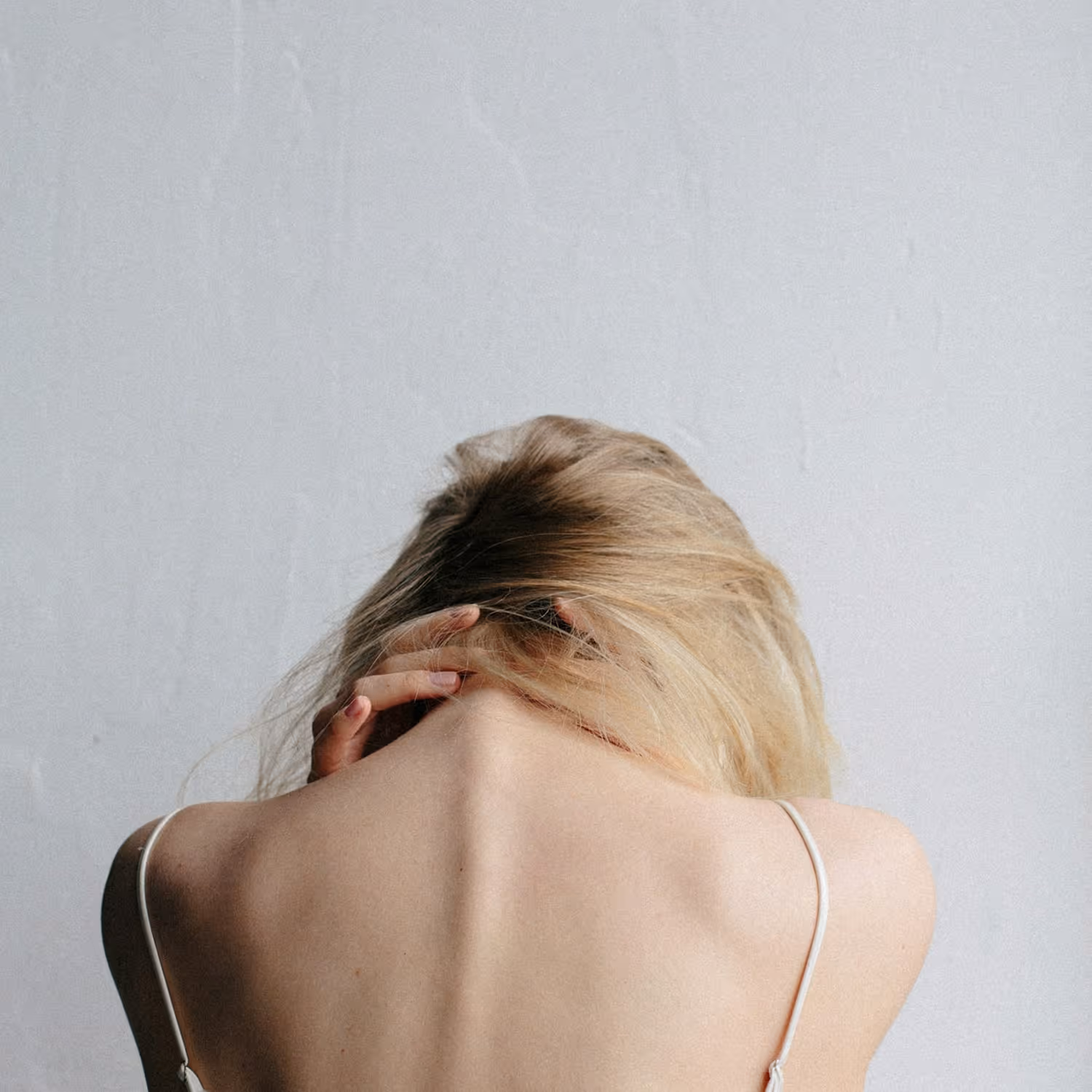A woman holding her neck in pain