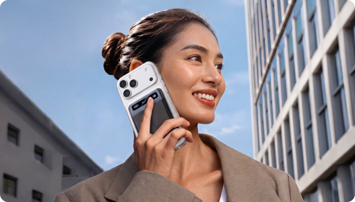 Woman holding her phone with MeetGeek Wave attached to the back, capturing a phone call