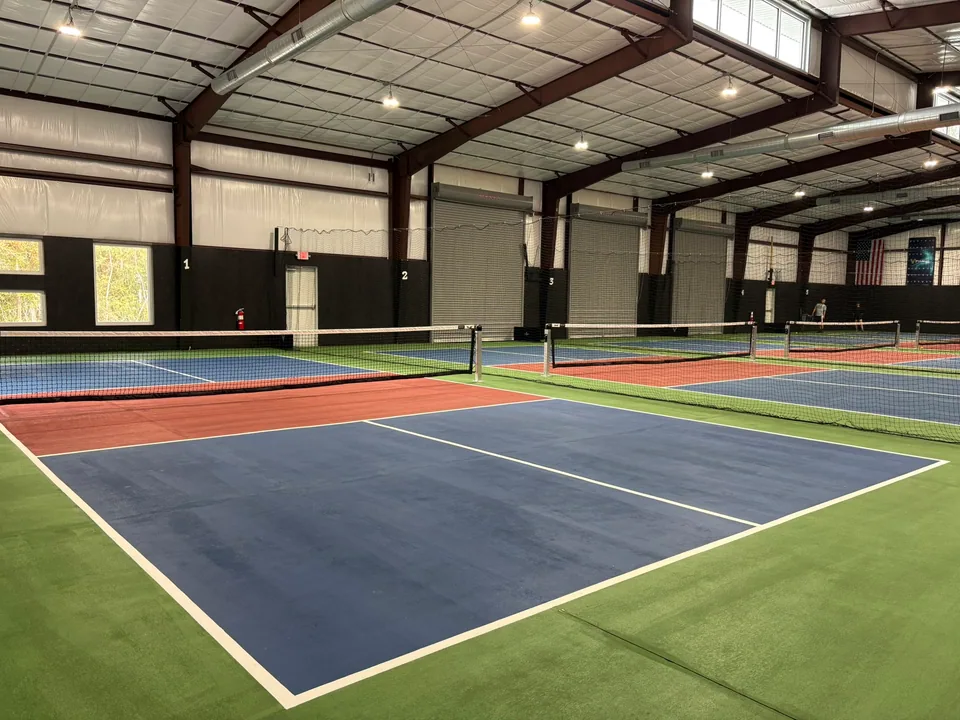 Pickleball 336: Painted courts beneath the exposed structure and ductwork