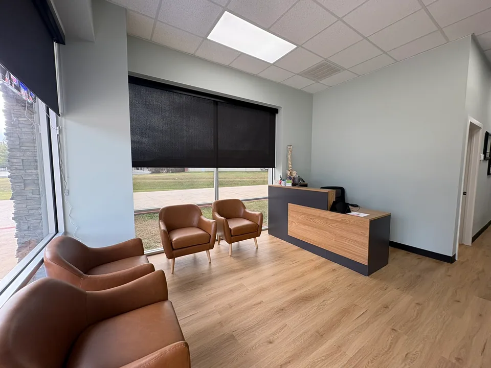 Hart and Hand Chiropractic: Reception desk, waiting area and wood-look flooring