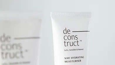 Tube of deconstruct NMF Hydrating Moisturiser with the tagline Safe, Sensible & Honest on a light background.