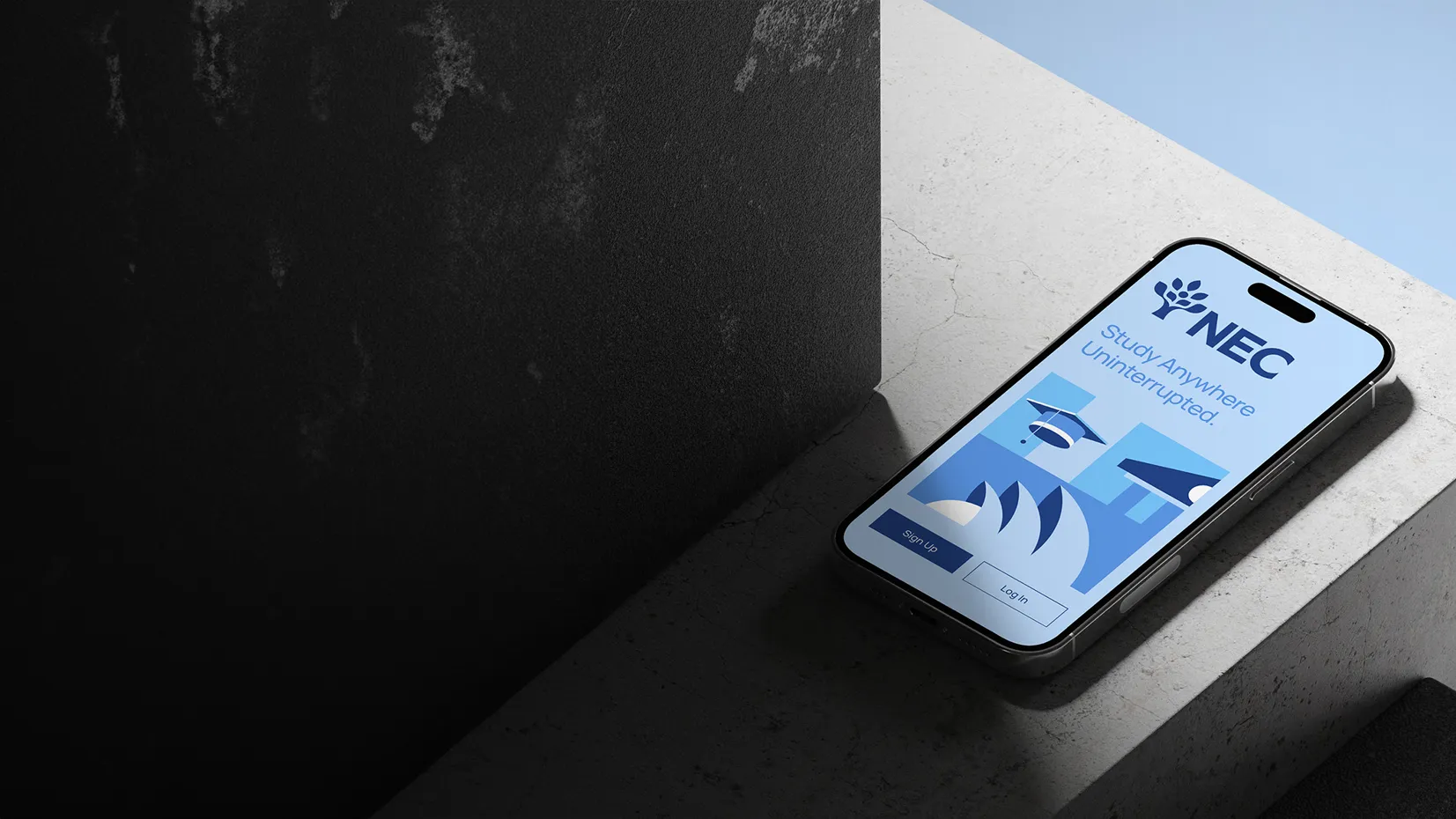 Smartphone displaying an NEC app interface with text 'Study Anywhere Uninterrupted', options to Sign Up or Log In, placed on a concrete surface.