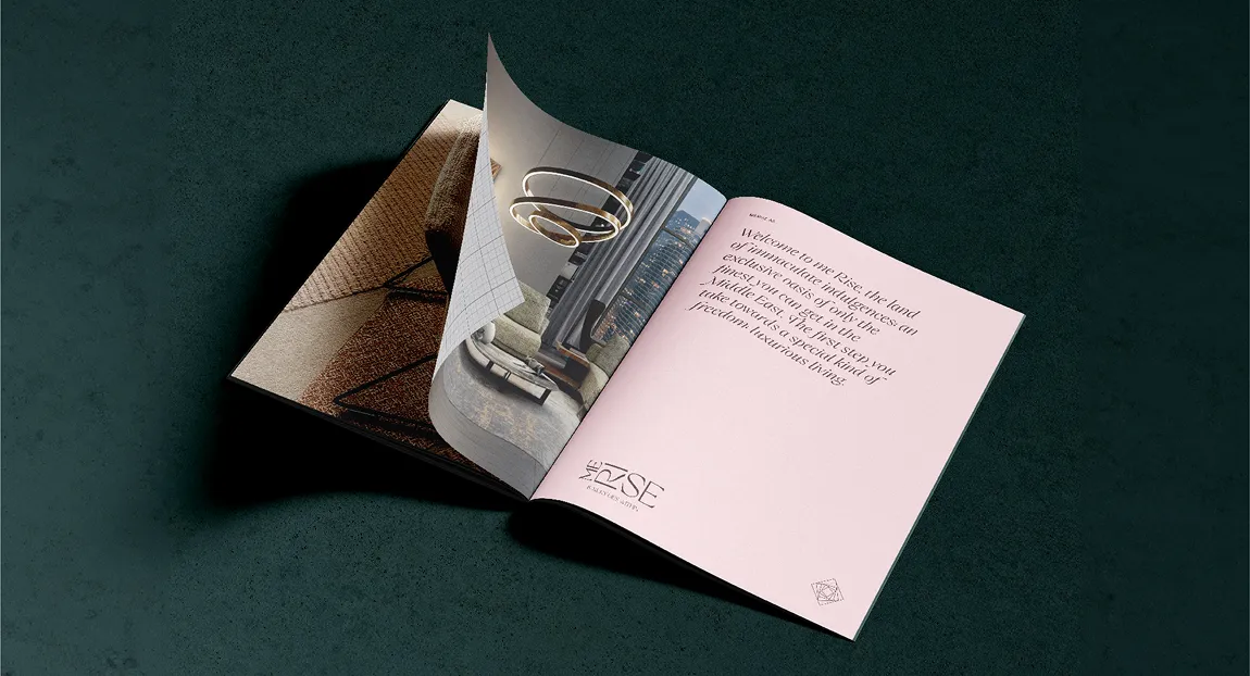 Open brochure on dark surface showing interior design with text welcoming to The Rise, featuring luxurious living spaces.