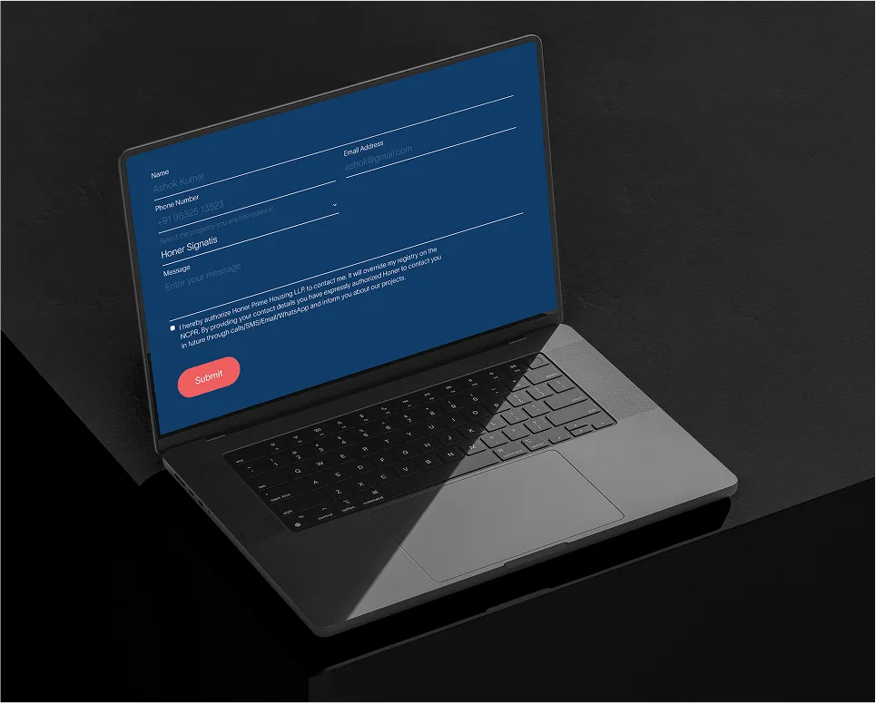 Laptop on black surface displaying a blue contact form with fields for name, phone number, email, property selection, message, and a red submit button.