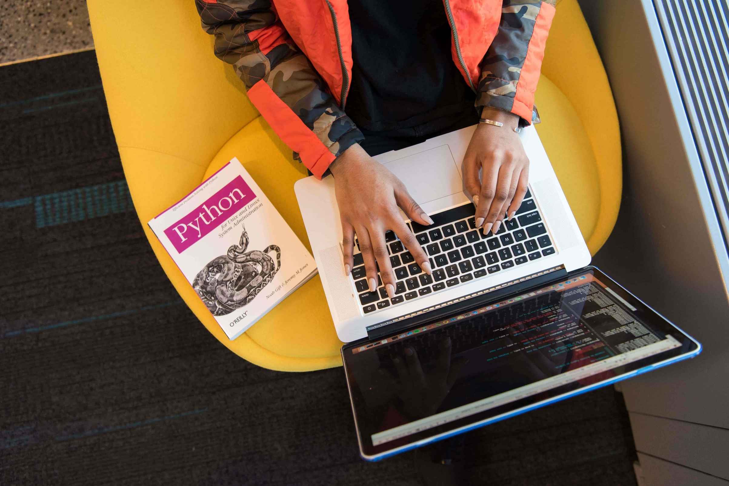 Woman collaborating on SaaS project ideas at a desk with laptop and notes