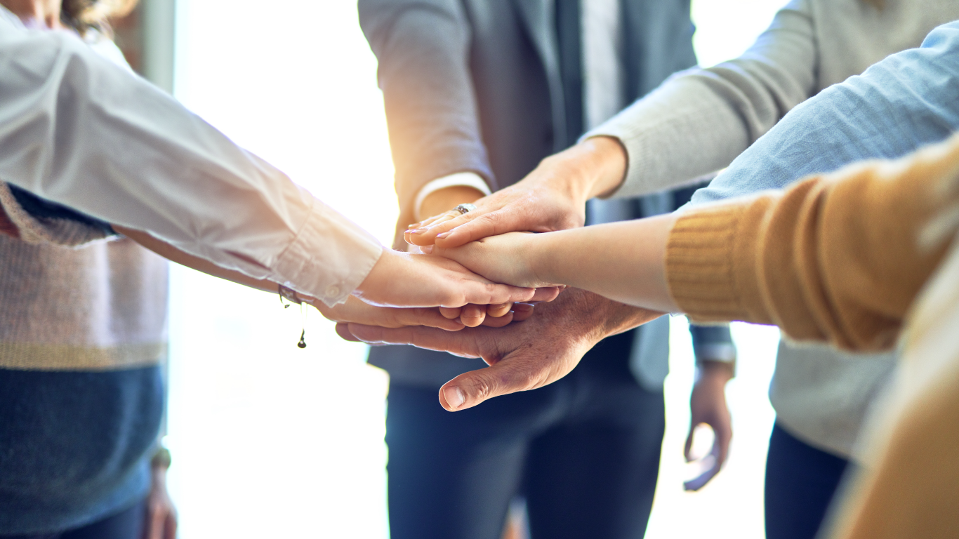 A team putting their hands together