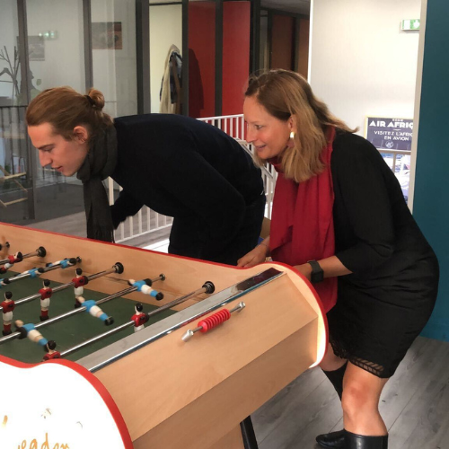 Greg (business consultant) and Alison (The boss), on a break, playing baby-foot together