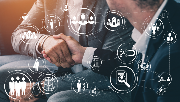 Guys shaking hand with lots of small drawing about business around them