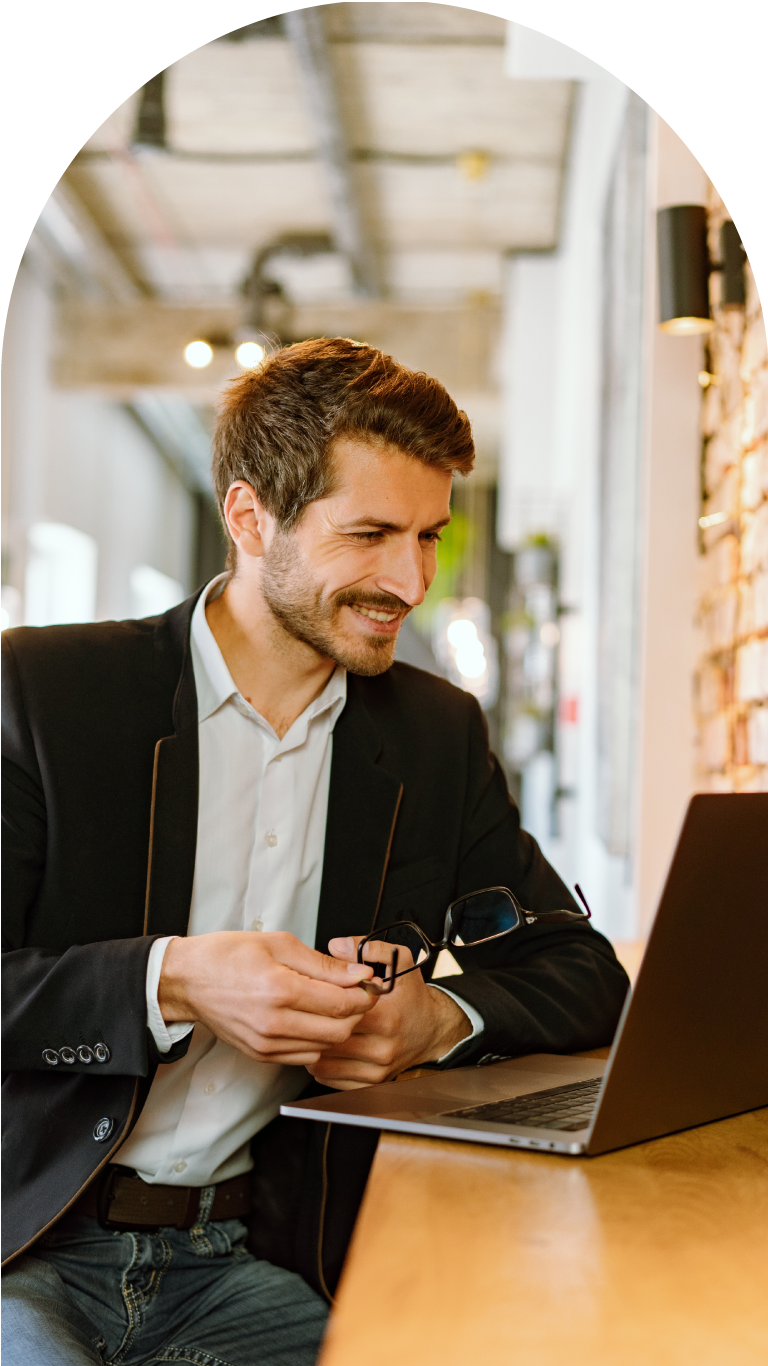 a business guy smiling while having his lesson on zoom with his awesome coach