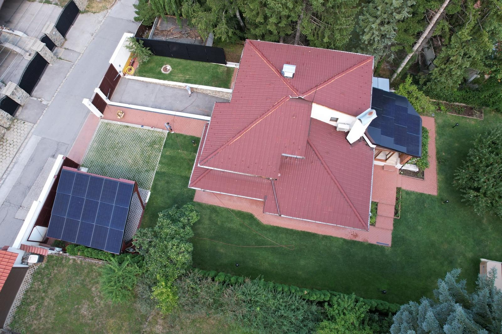 Aerial view of a Bulgarian property with a solar carport, an integrated solar roof and a RAULI FENCE solar fence