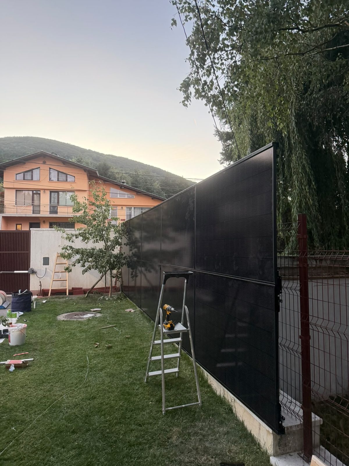 Installation of the RAULI FENCE solar fence in progress in a Bulgarian garden