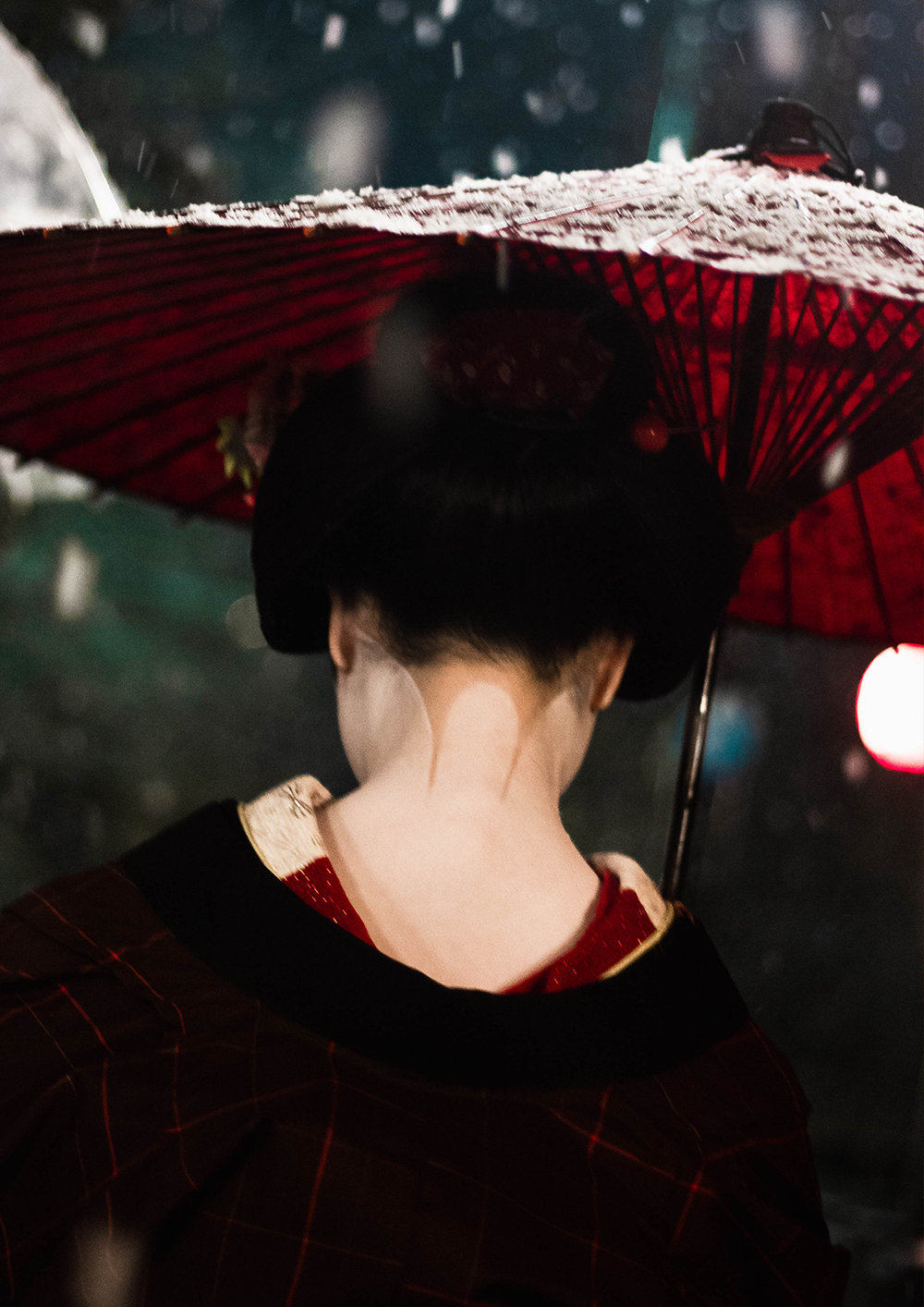 Photo of a woman holding an umbrella and her skirt with the other hand, walking down the street in the pouring rain,