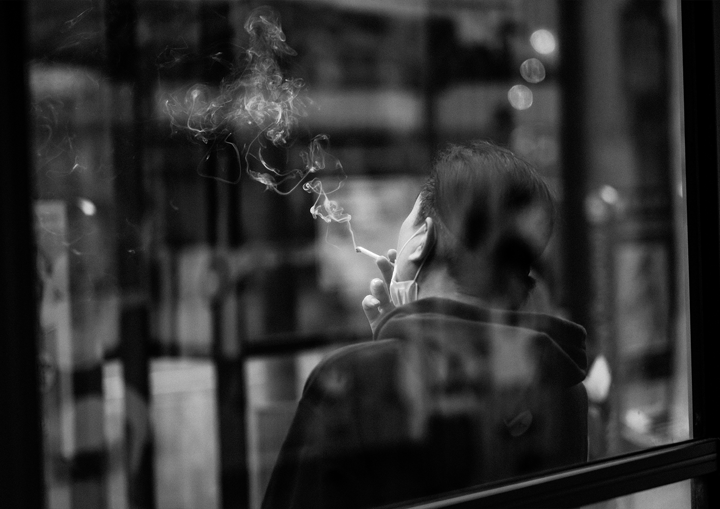 Photo of a woman holding an umbrella and her skirt with the other hand, walking down the street in the pouring rain,