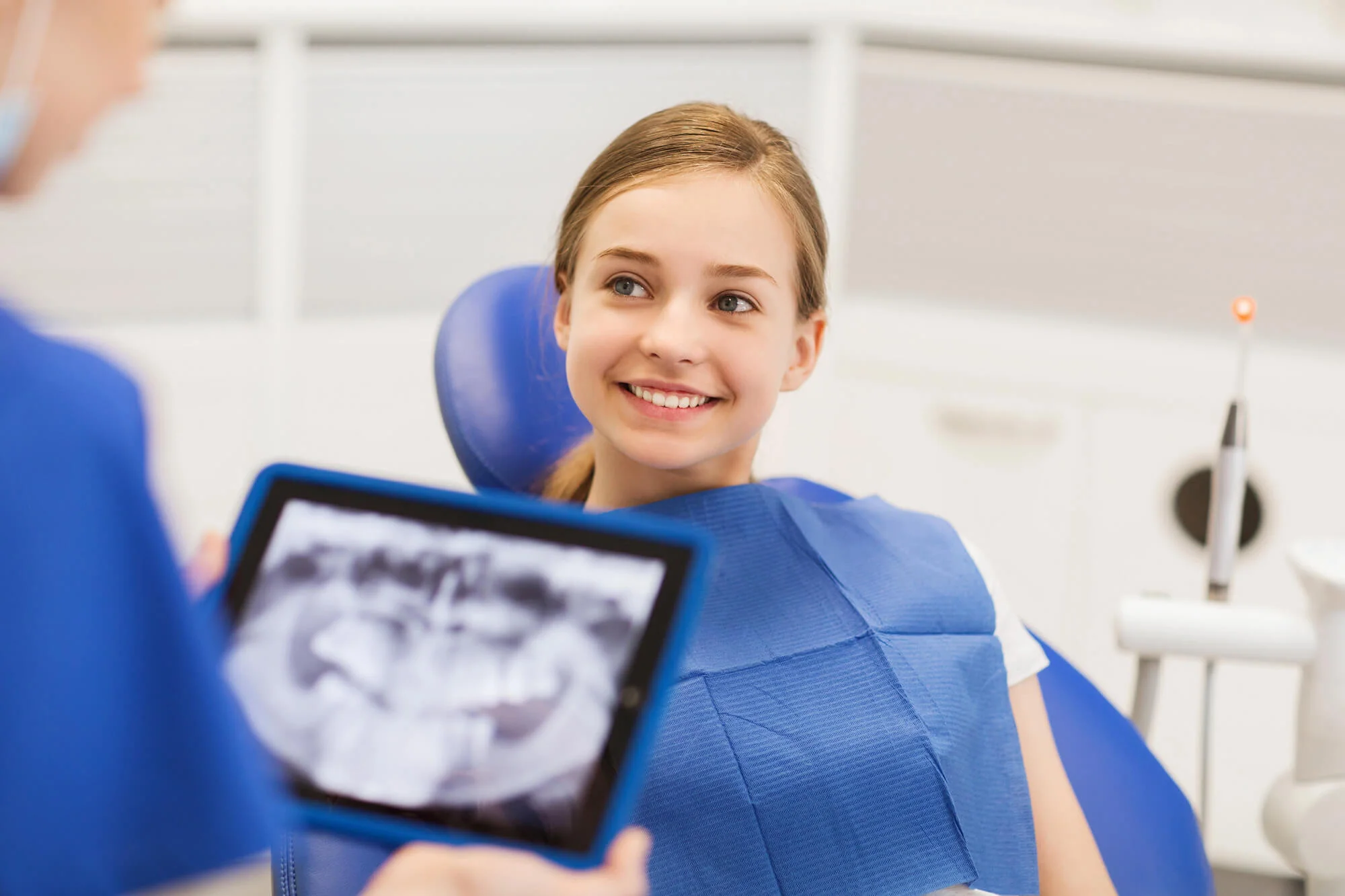 Young girl smiling at her Pediatric dentist in Butler