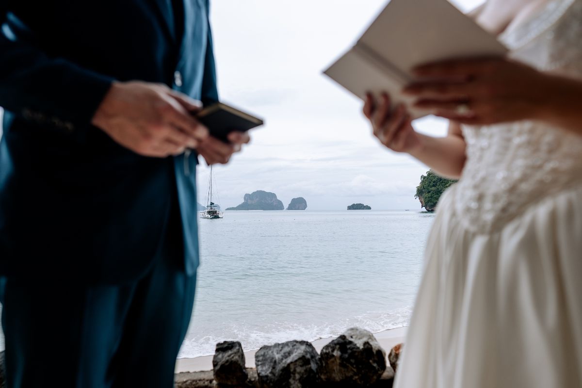 elopement couple reading vows in the grotto rayavadee thailand krabi