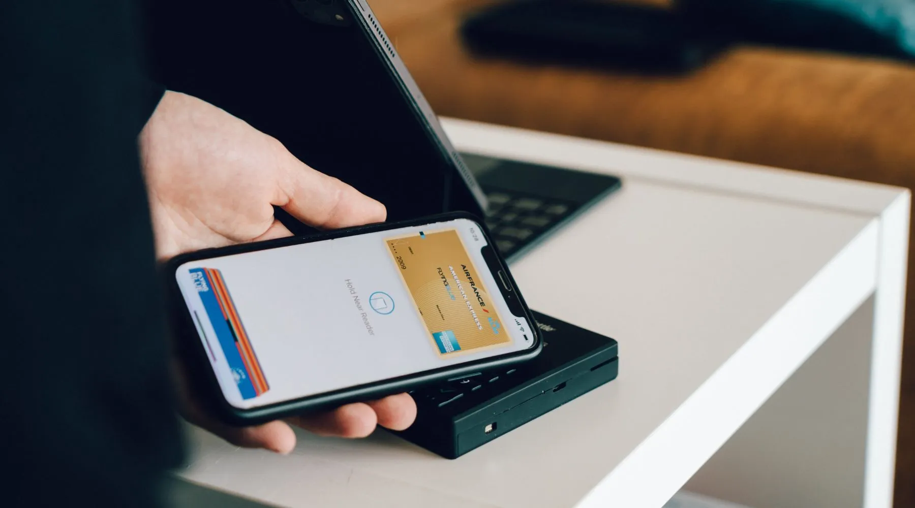 a person paying with an apple pay at a table