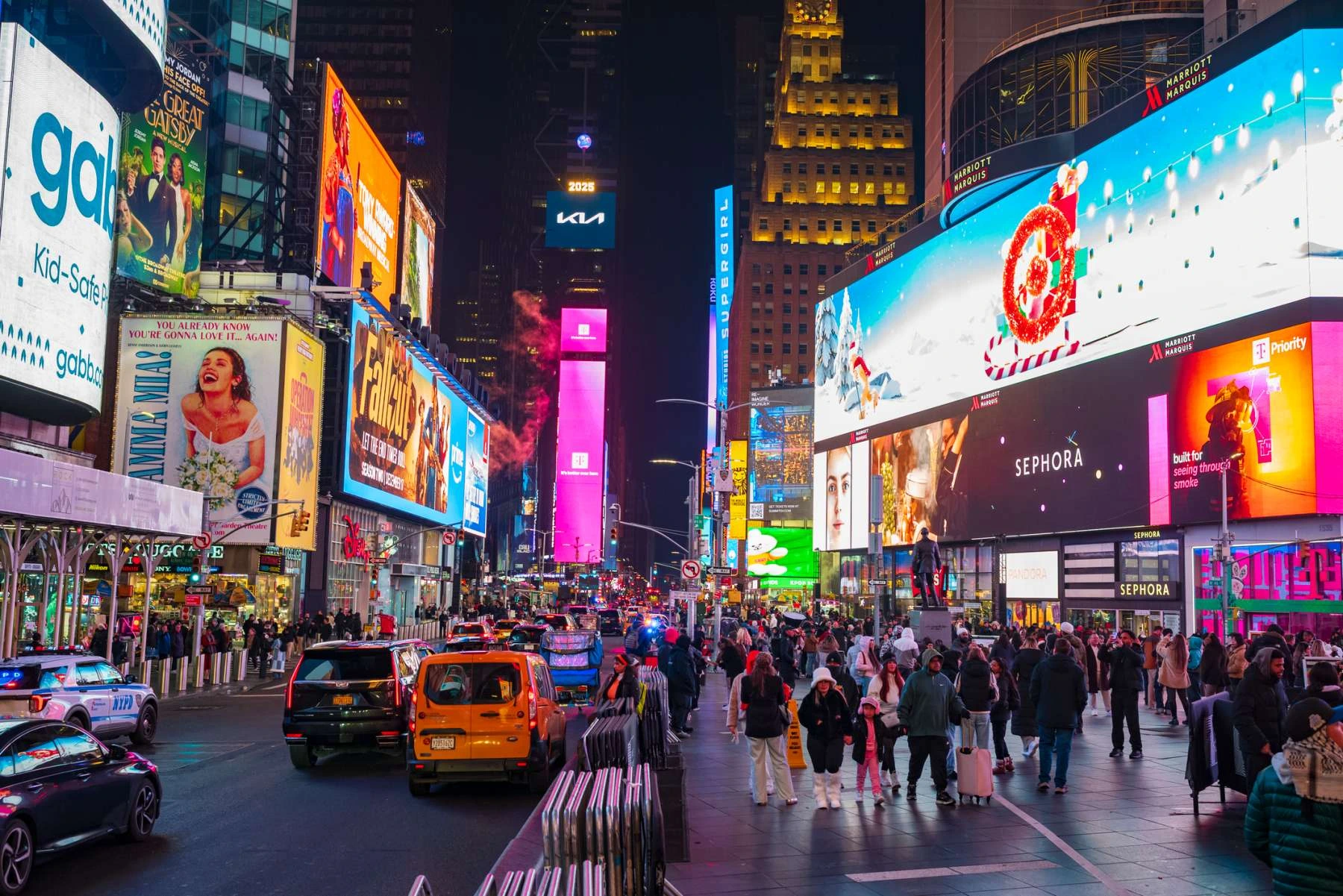 imes Square New York City at night with bright lights and billboards