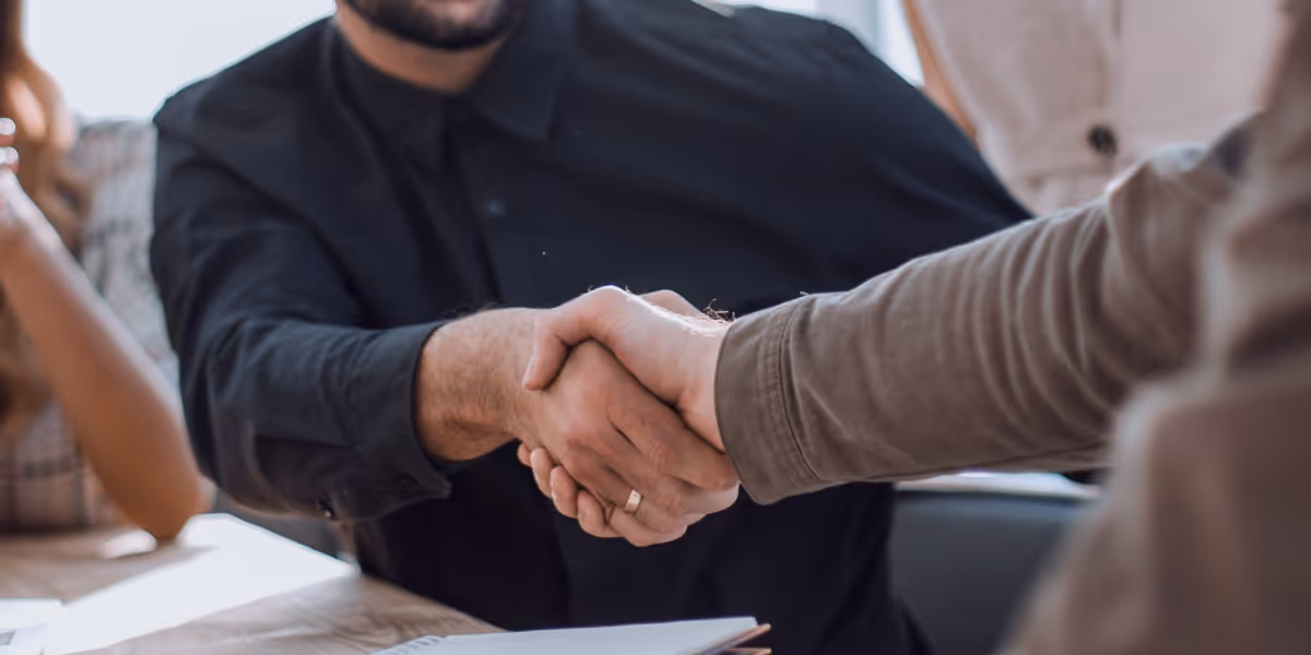 People agreeing on a deal, shaking hands