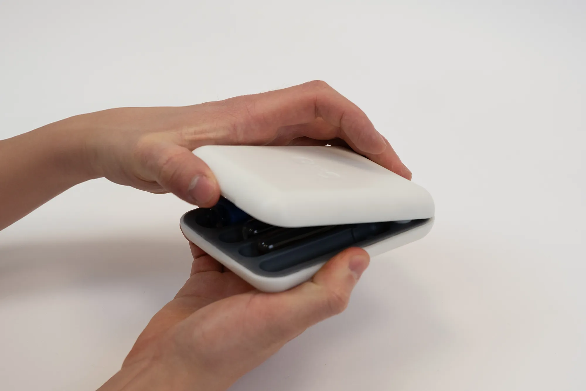 Person holding a prototype of a carrying case for Pacifi's probiotic applicator kit.