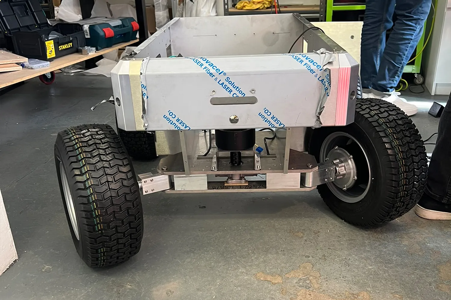 A partially assembled robot in a workshop.