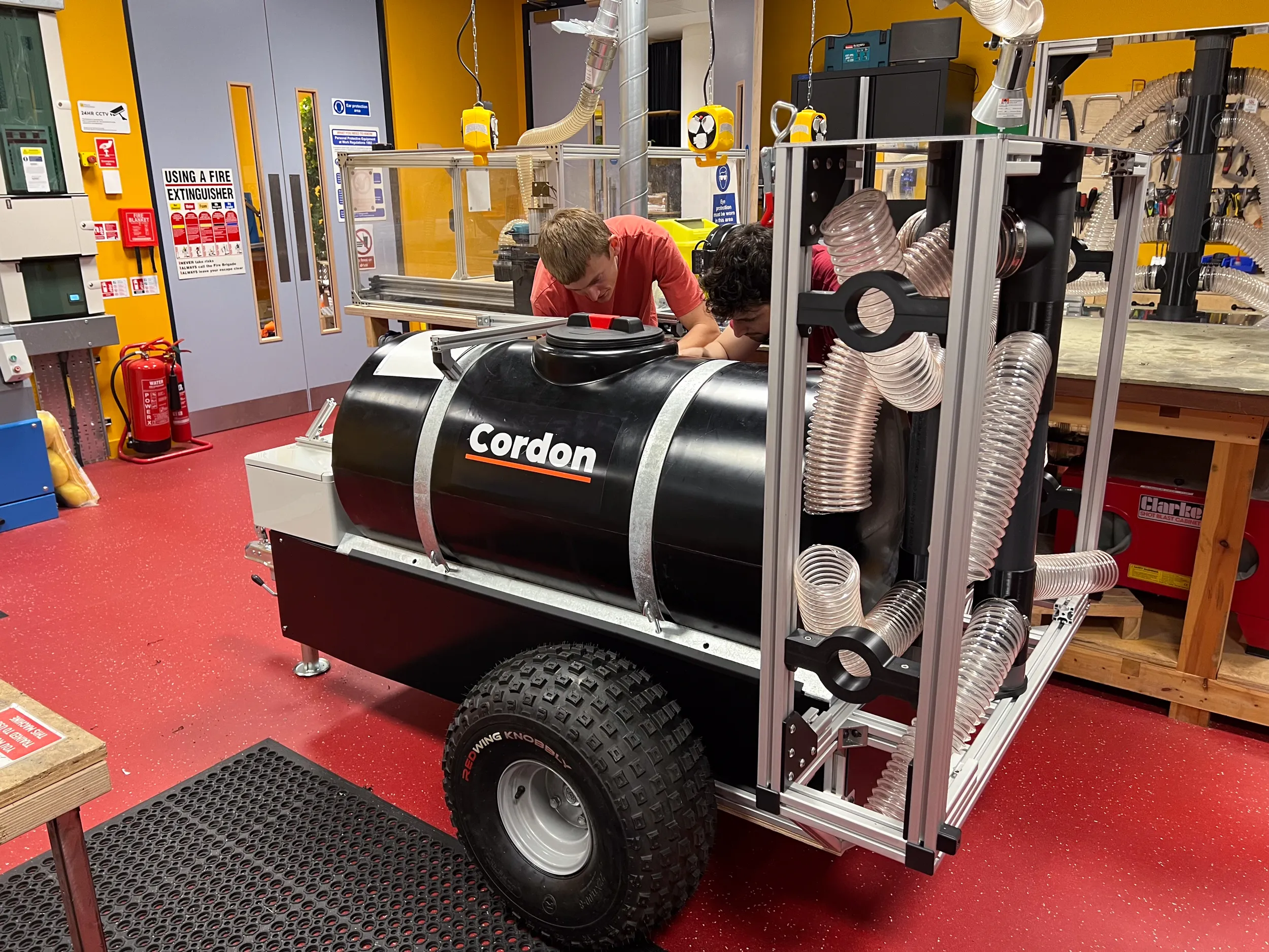 Members of the Studio Matter team assembling a full-scale sprayer prototype in a workshop.