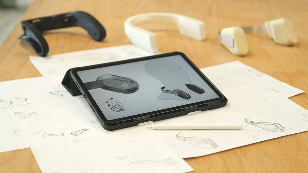 Sketch concepts of the Sixth Sense wearable alongside early-stage form models.