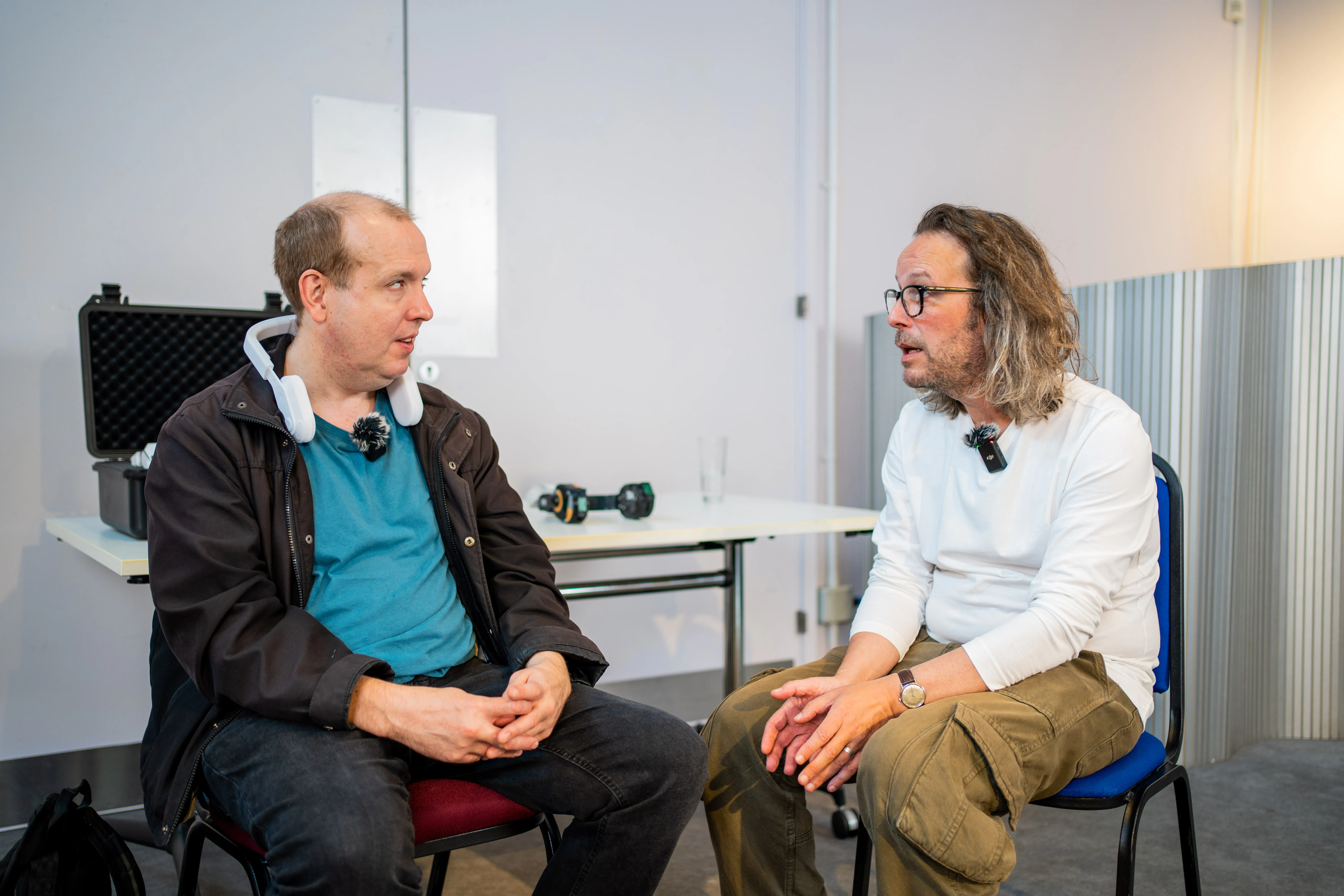 Jim Reeves discussing the Sixth Sense product with a visually impaired user, who is wearing a prototype.