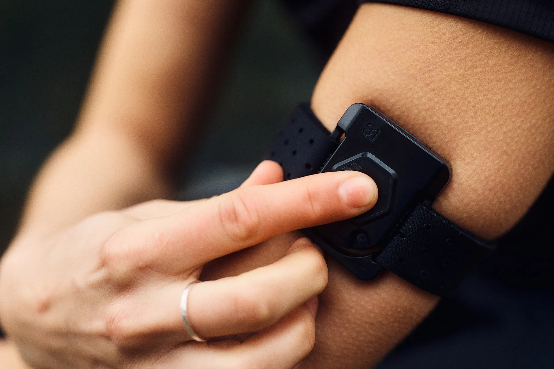 Person using a FLOWBIO smart hydration sensor.
