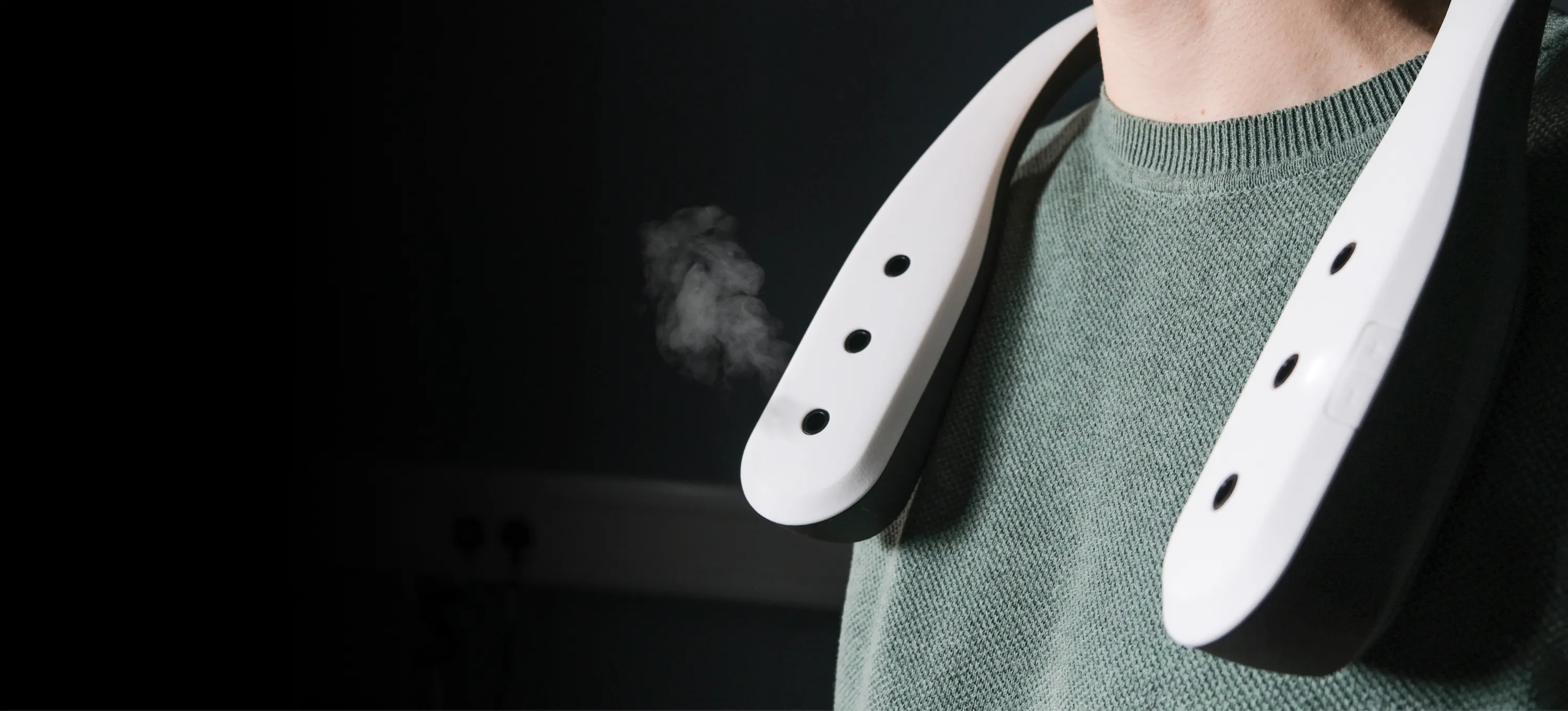 Scentient Escents device around a user's neck, puffing scent.