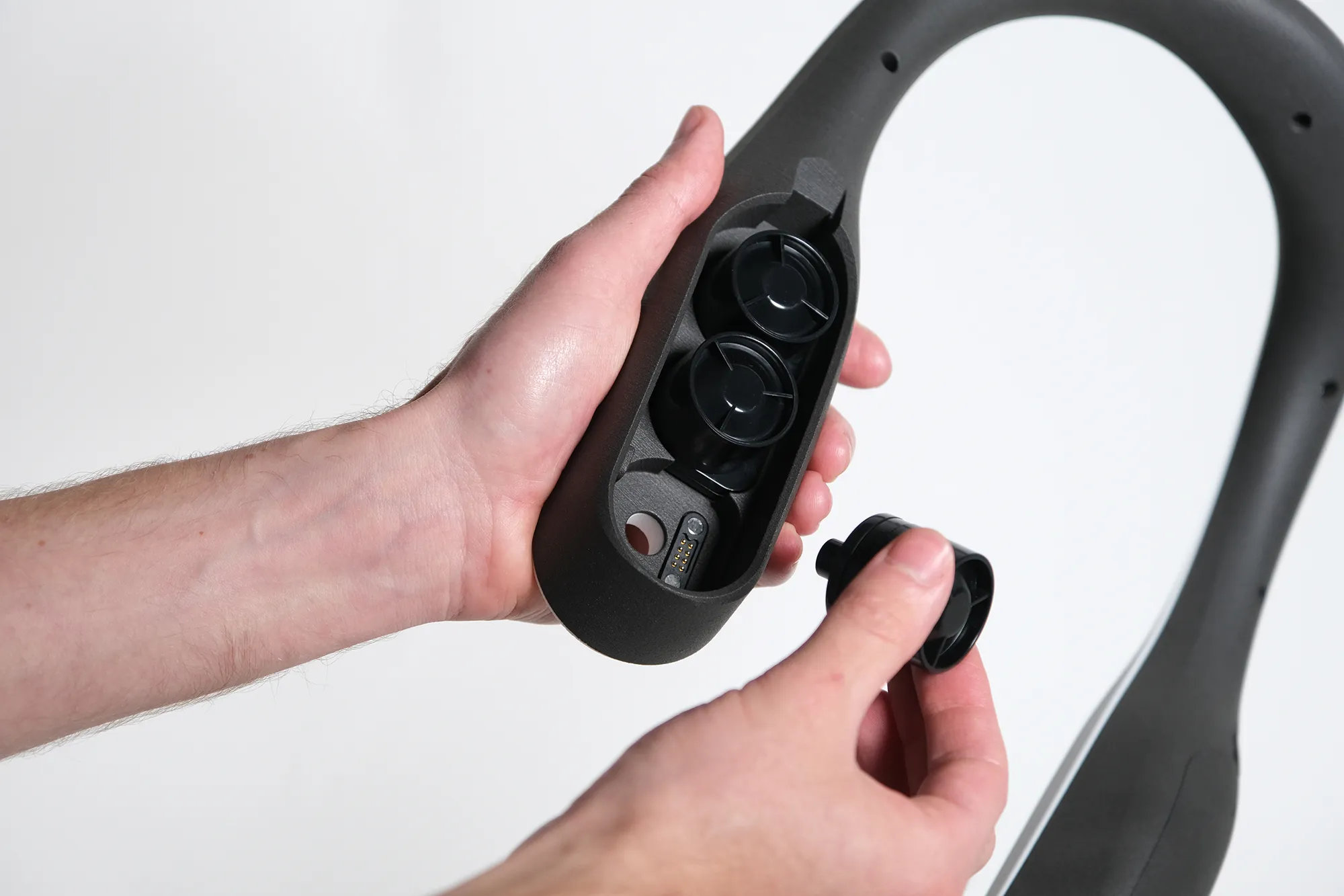 A person inserting scent pods into the Scentient Escents device.