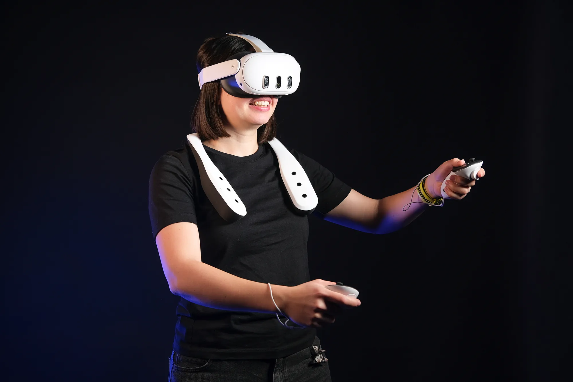 A woman using the Scentient Escents device in combination with a VR headset.