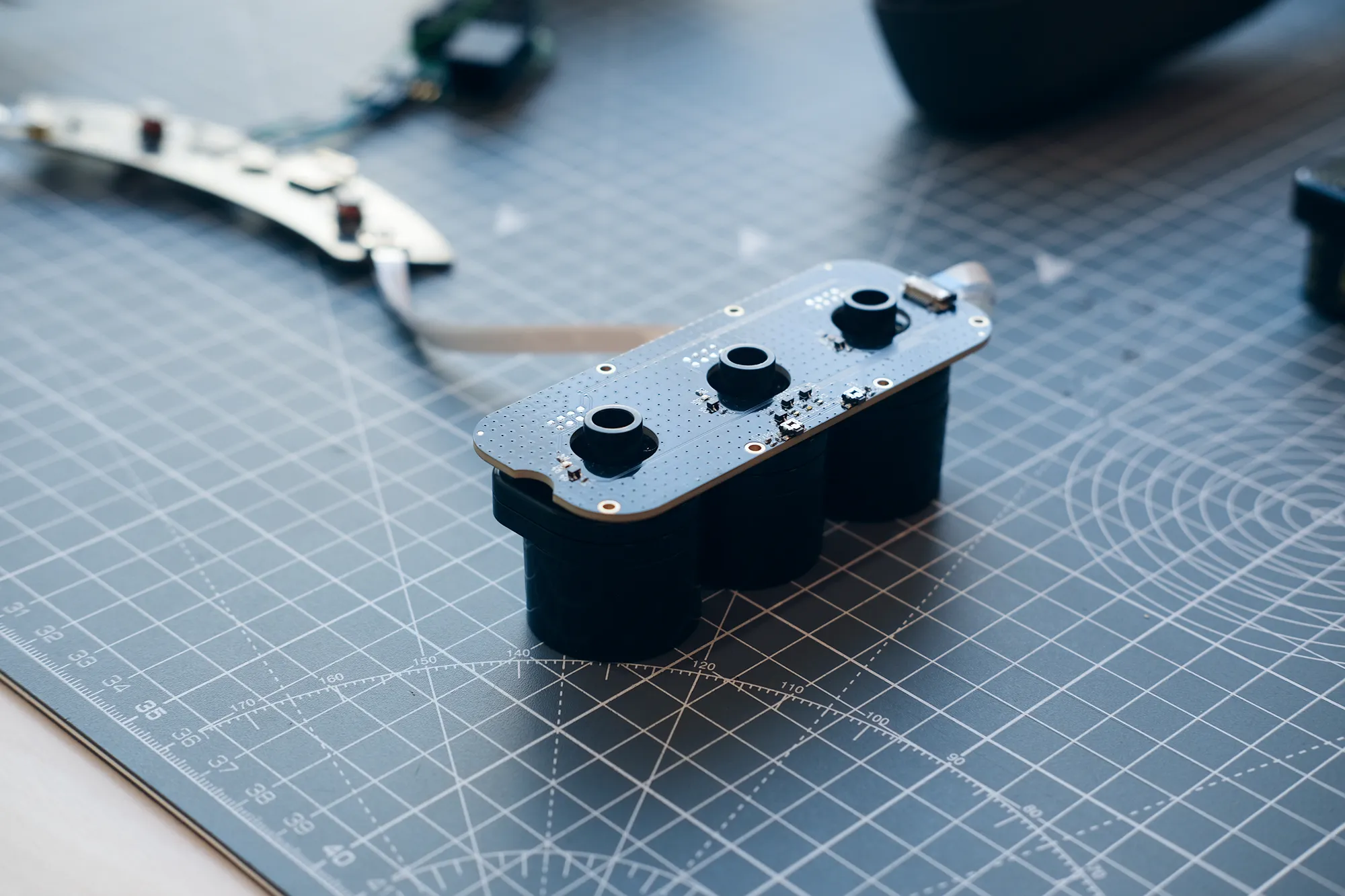 Internal electronics of Scentient Escents device on a grey cutting mat.