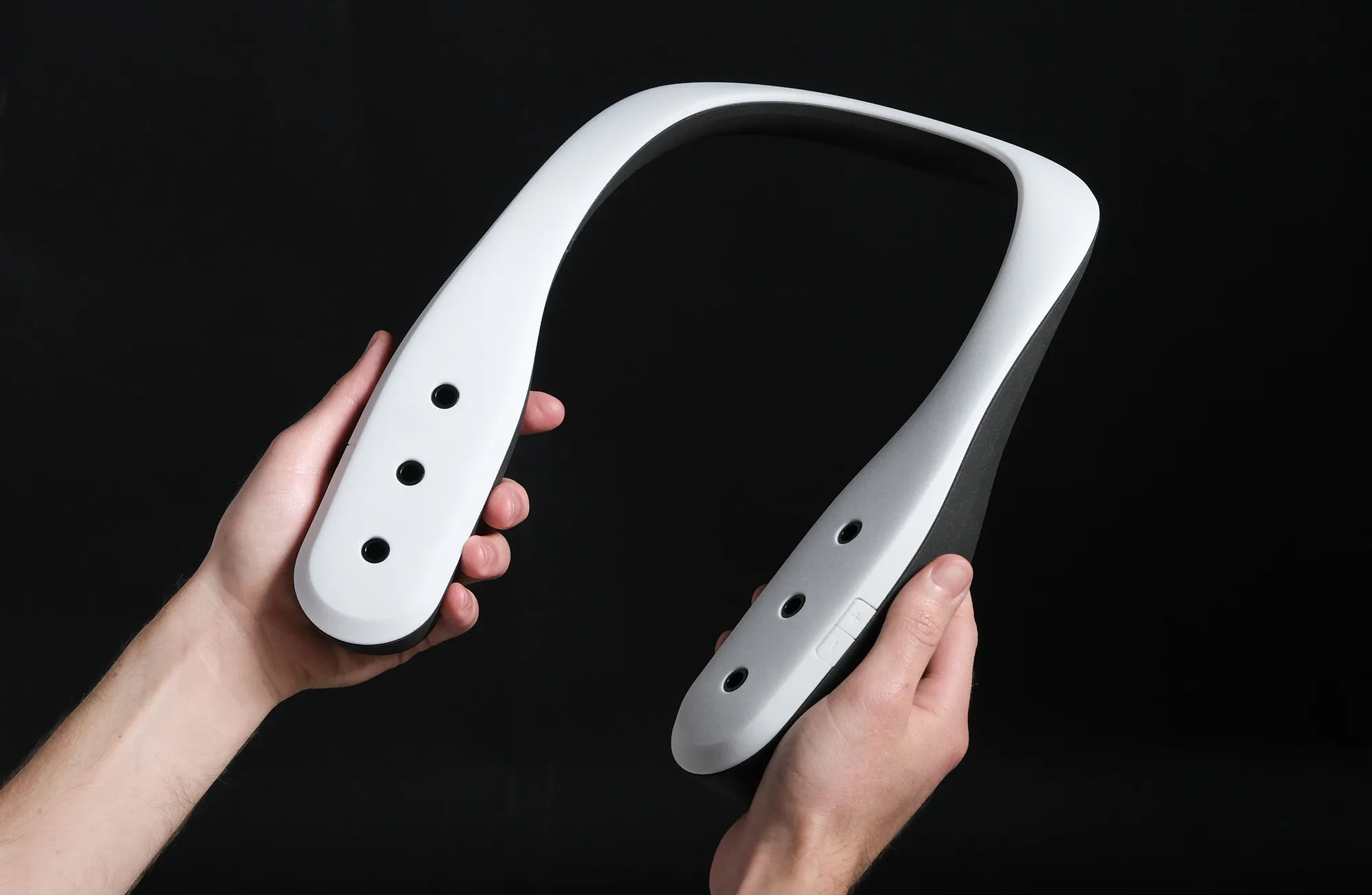 A person holding a Scentient Escents device in their hands.