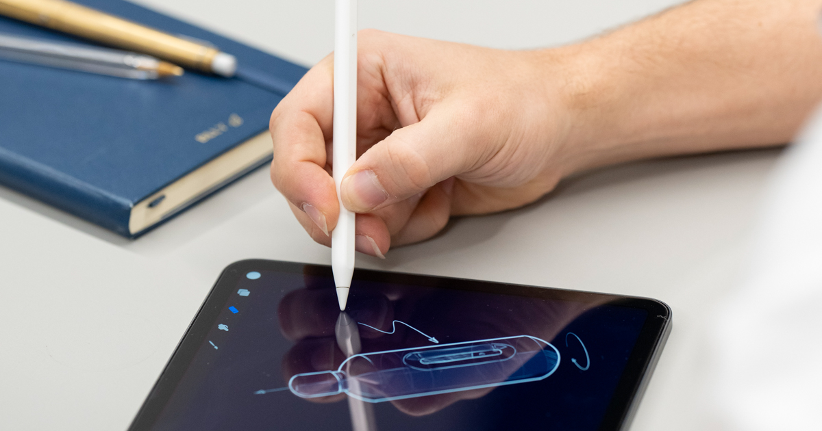 A person sketching an industrial design concept on an iPad.