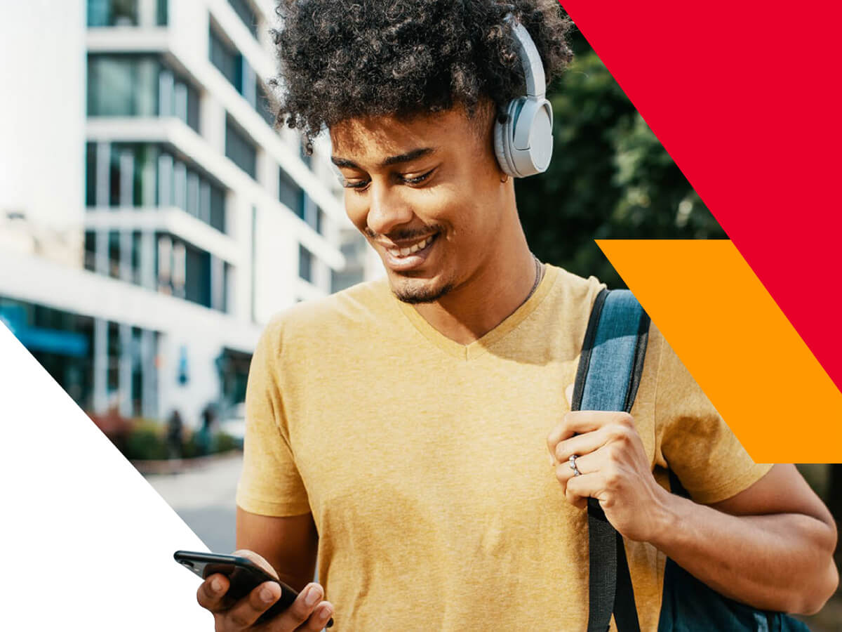 Young adult walking outside using a phone to message a nurse