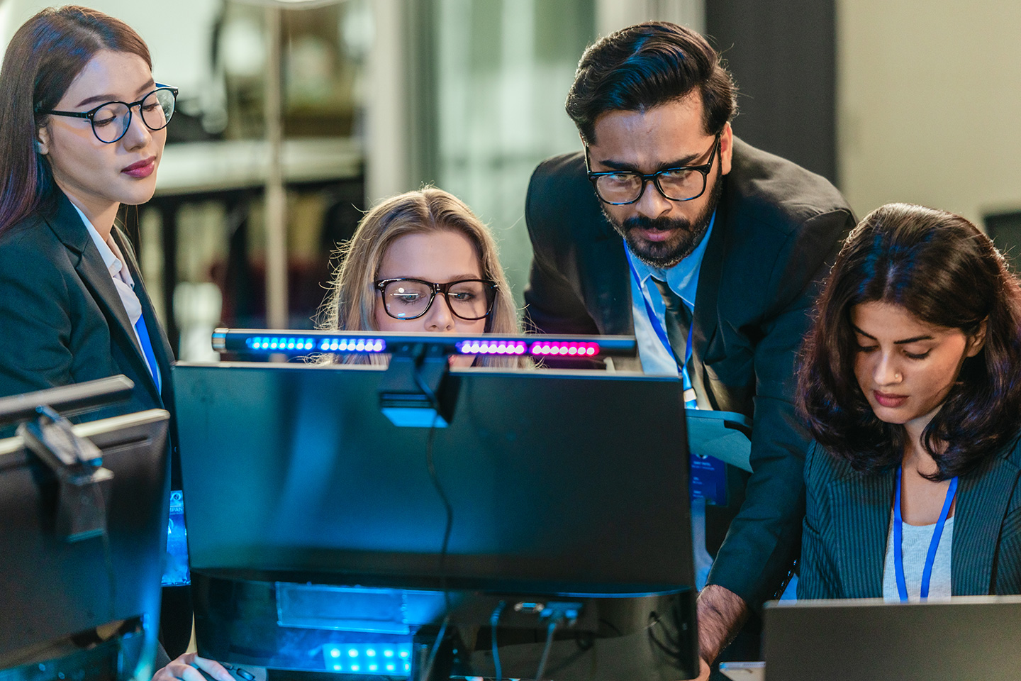 Cybersecurity team gathered around a computer searching GovRAMP compliance services