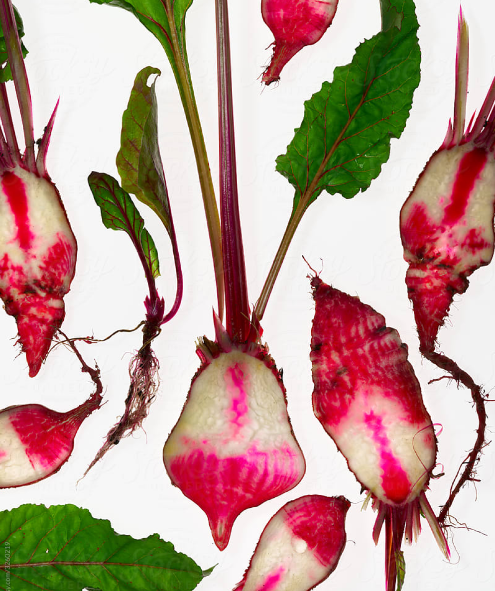 Close up of vertically sliced beets placed throughout the frame