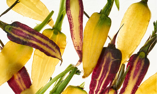 A close up of vertically sliced peppers  to allow you to see the core