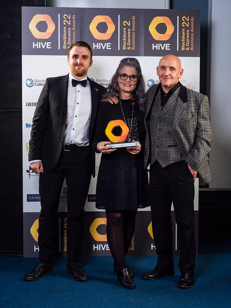 APM Design team members holding the Hive Business Award in 2022