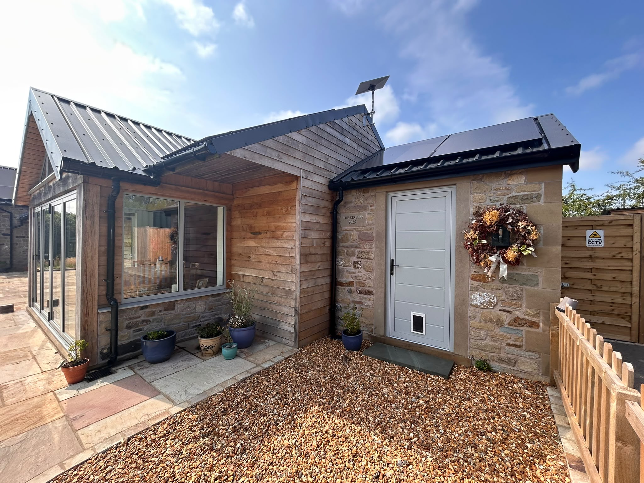 Off grid house, oak cladding with stone. Starlink for home connectivity.